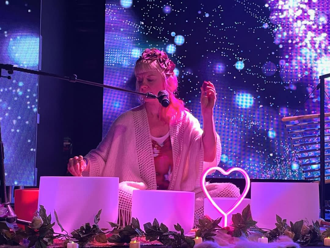 Chris leading a sound healing session on stage